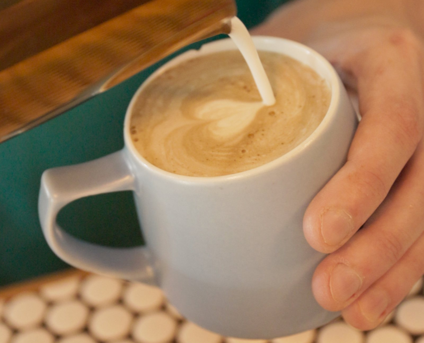 Latte with latte art in a white mug at the Crossroads café